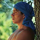 Boy leaning on tree