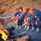 Woman and girls at campfire